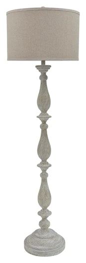 A distressed antique white floor lamp with a carved wooden-style base and a neutral beige fabric drum shade.