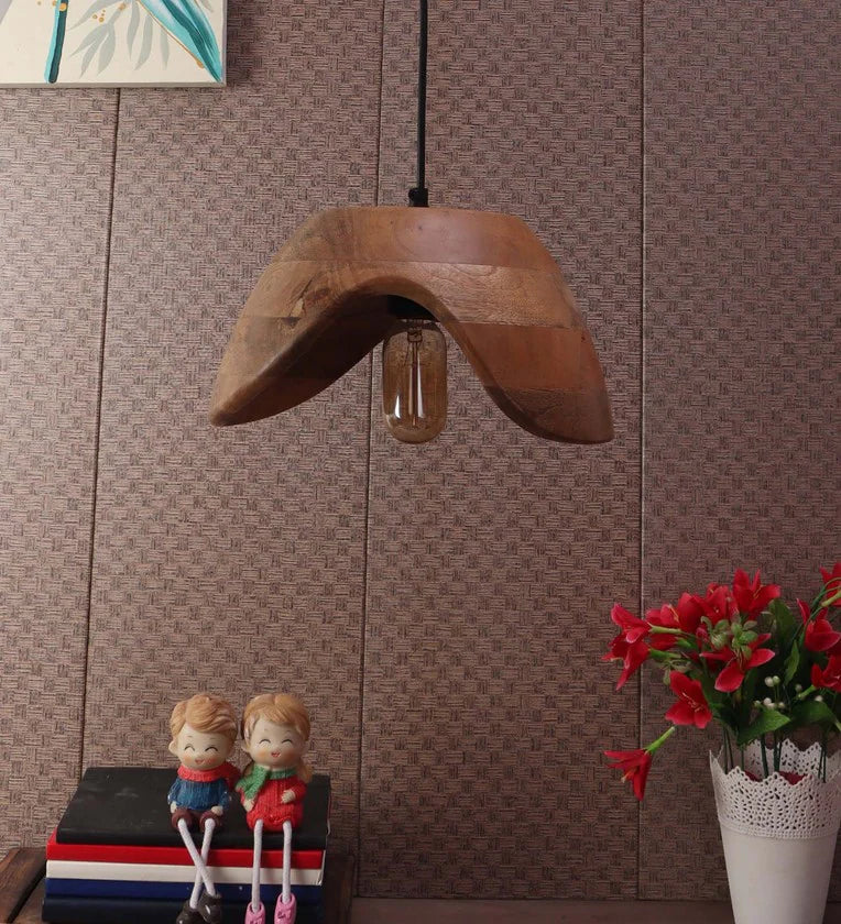 A modern hanging pendant light featuring a curved, wave-shaped natural mango wood shade with an exposed vintage Edison bulb.
