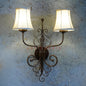 AnticoArte Victorian Twin Arm Wall Sconce | Bronze Wrought Iron Double Linen Shade Wall Lamp | Ornate Scroll Antique Wall Light for Home & Hotel Decor