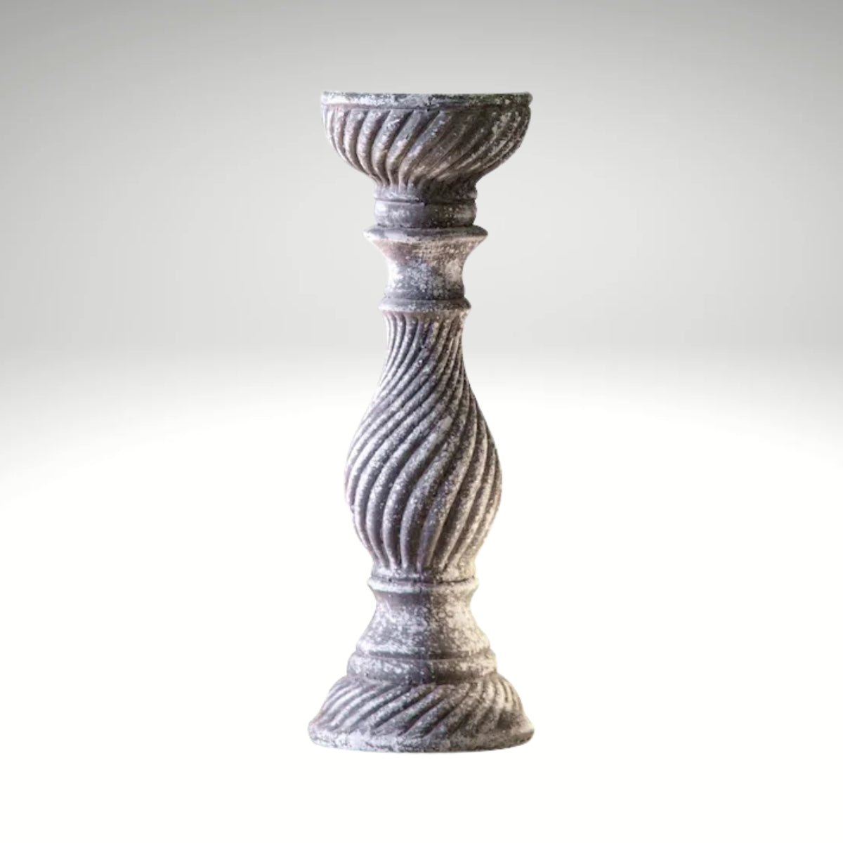 A rustic, grey candlestick holder featuring a distressed finish