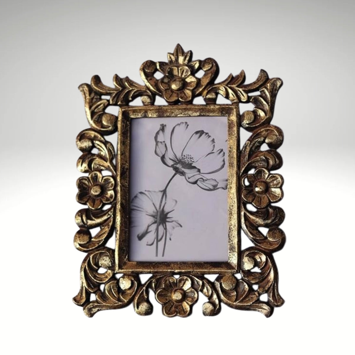 A rectangular photo frame with an ornate, hand-carved antique gold border