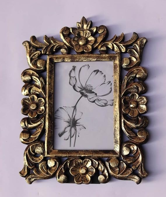 A rectangular photo frame with an ornate, hand-carved antique gold border
