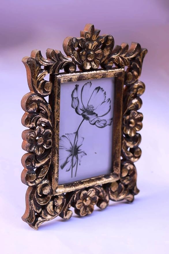 A rectangular photo frame with an ornate, hand-carved antique gold border