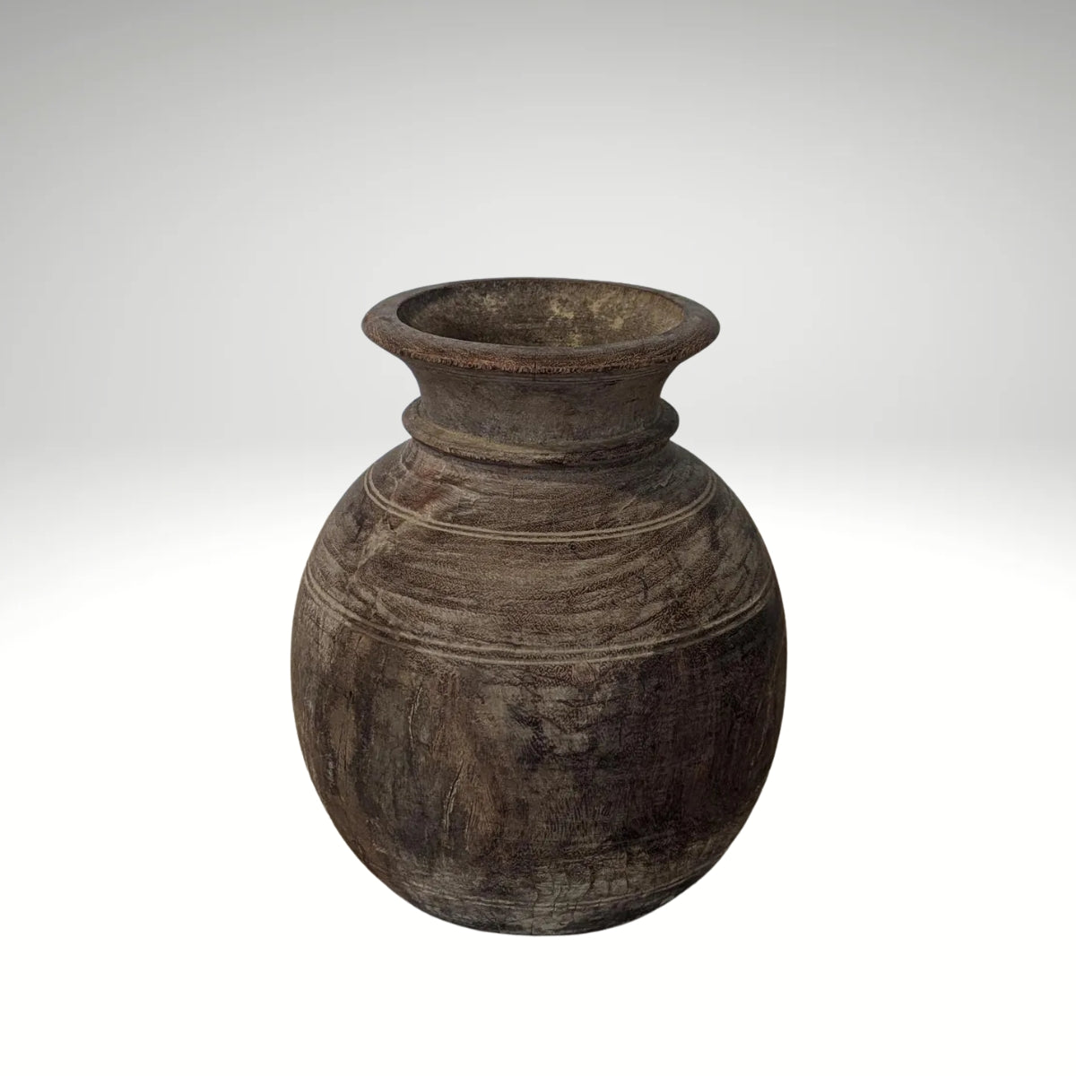 A round, dark brown rustic wooden vase