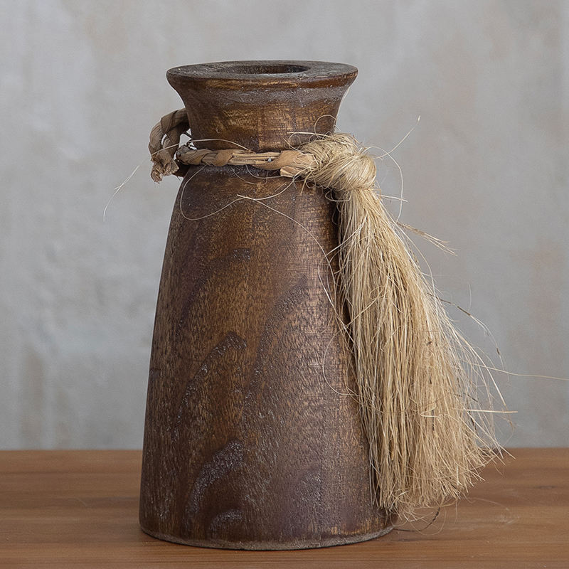 A pair of rustic brown wooden vases in different sizes, each decorated with a jute rope tassel tied around the neck.
