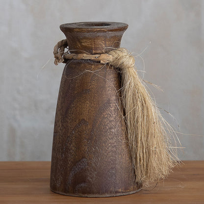 A pair of rustic brown wooden vases in different sizes, each decorated with a jute rope tassel tied around the neck.
