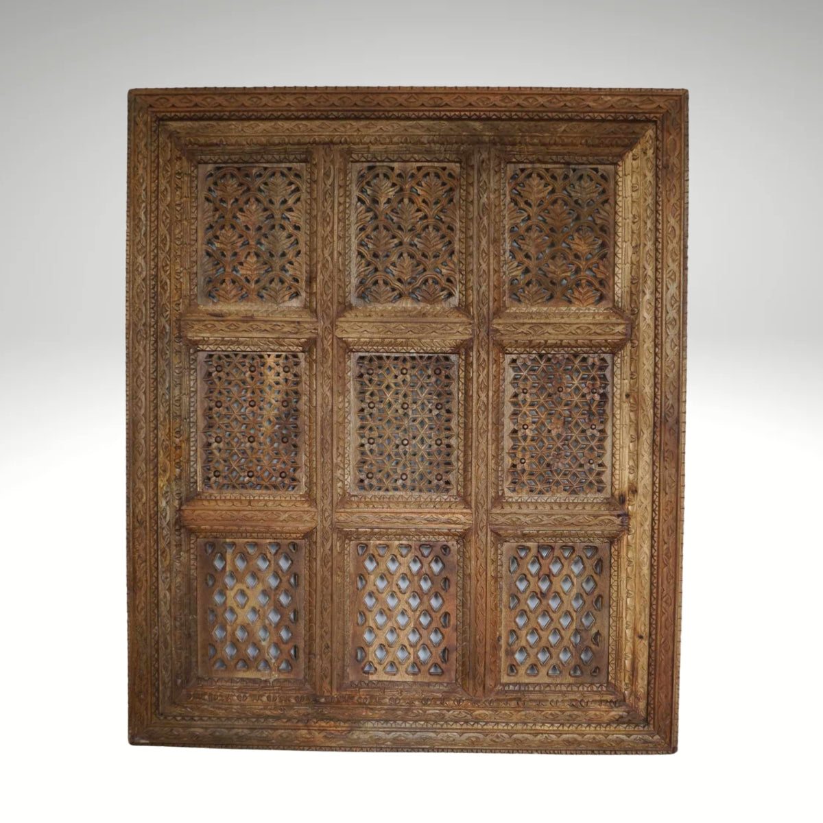 A hand-carved square wooden wall panel featuring a nine-grid design with intricate floral and geometric openwork lattices.