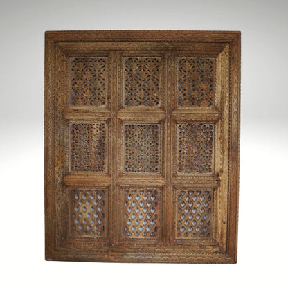 A hand-carved square wooden wall panel featuring a nine-grid design with intricate floral and geometric openwork lattices.