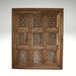 A hand-carved square wooden wall panel featuring a nine-grid design with intricate floral and geometric openwork lattices.