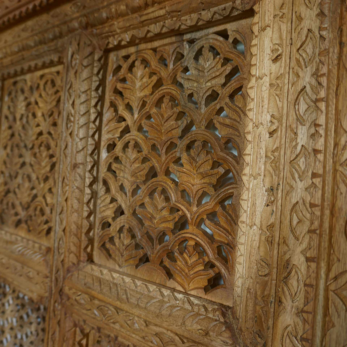 A hand-carved square wooden wall panel featuring a nine-grid design with intricate floral and geometric openwork lattices.