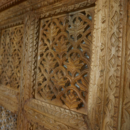 A hand-carved square wooden wall panel featuring a nine-grid design with intricate floral and geometric openwork lattices.