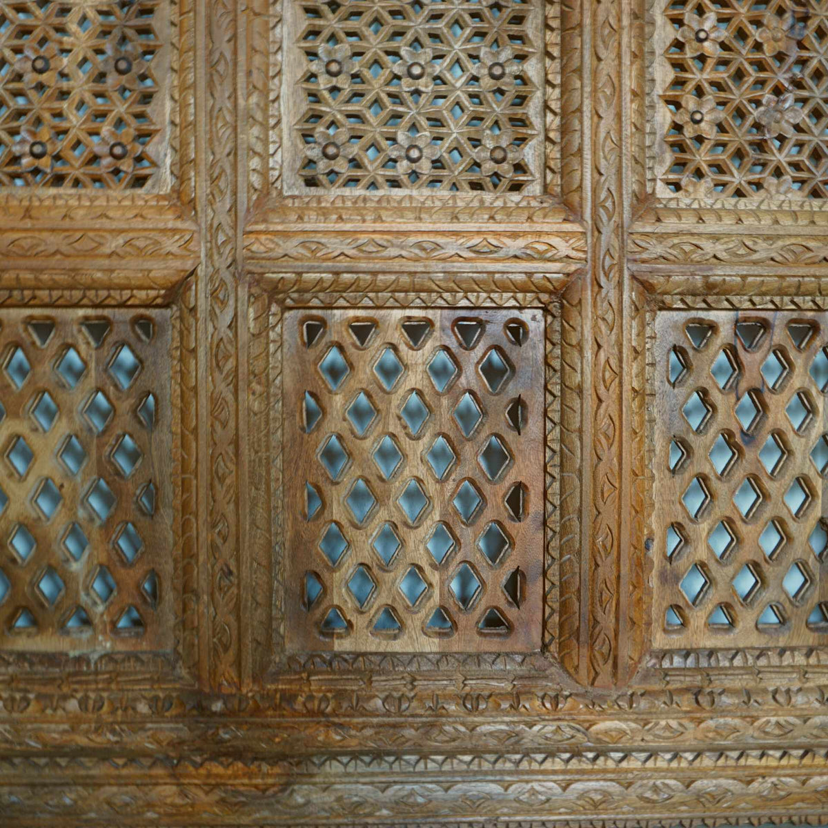 A hand-carved square wooden wall panel featuring a nine-grid design with intricate floral and geometric openwork lattices.