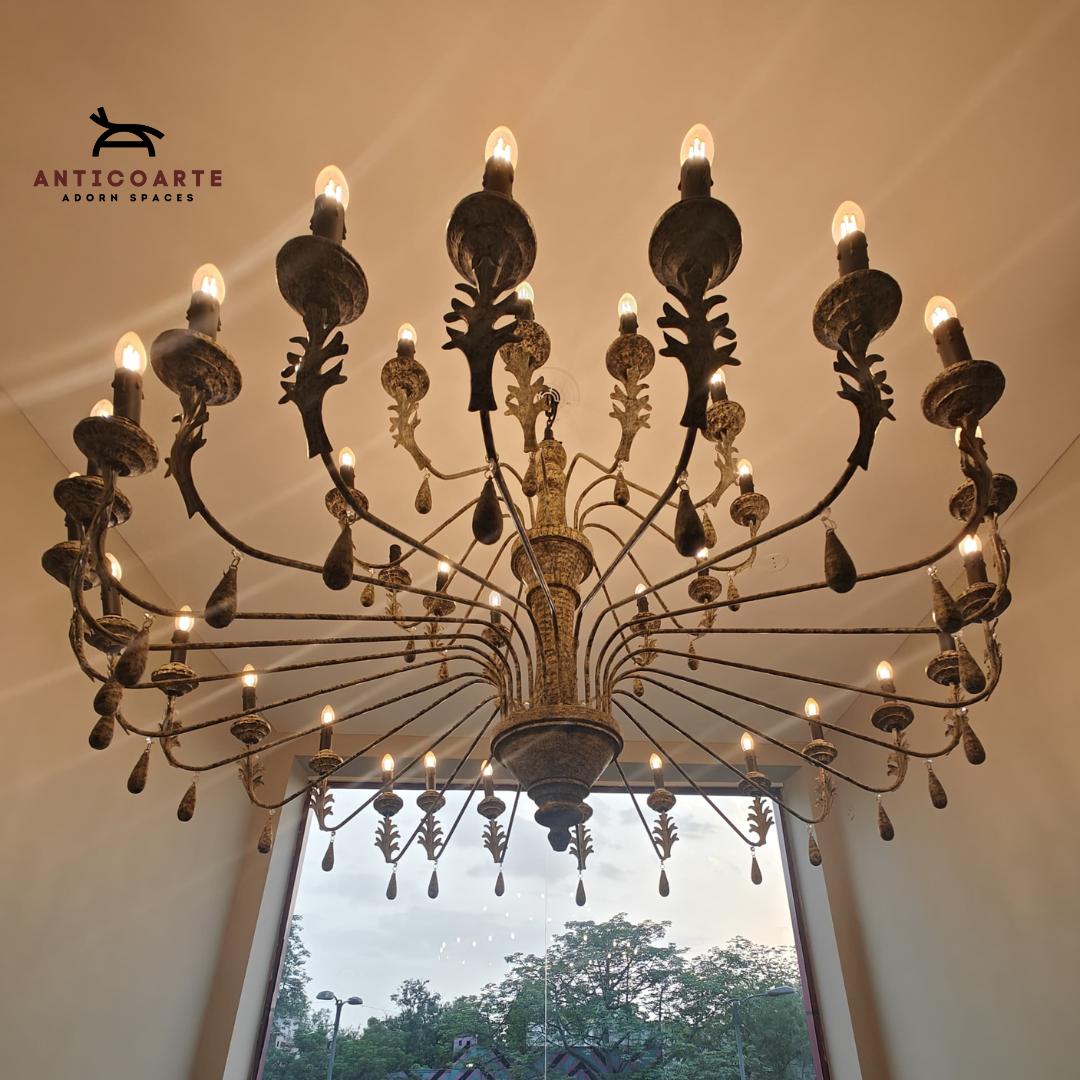 Large antique tiered candle chandelier with a Patine finish.