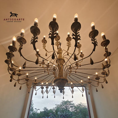 Large antique tiered candle chandelier with a Patine finish.
