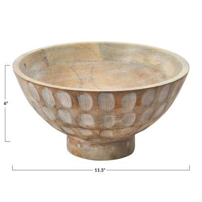 A round, natural mango wood bowl with a footed base and a carved, circular pattern decorating the outer surface.