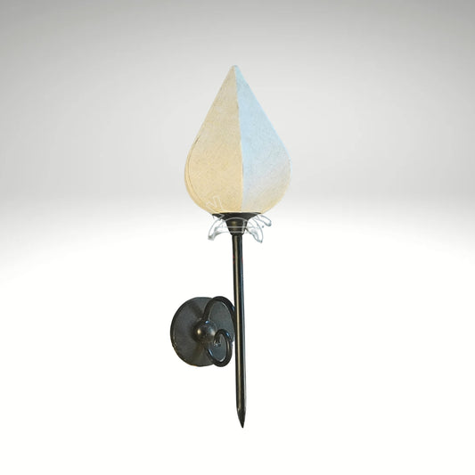 A wall-mounted light fixture shaped like a lotus bud with a white fabric shade and a black metal torch stem.