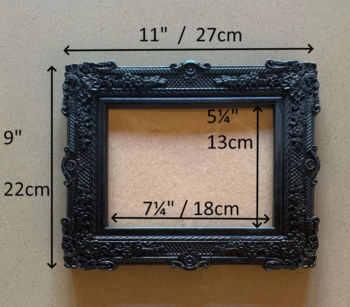  An ornate, dark brown antique-style photo frame with intricate floral carvings 