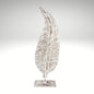  Distressed white metal leaf statue with rustic brown accents mounted on a stand.
