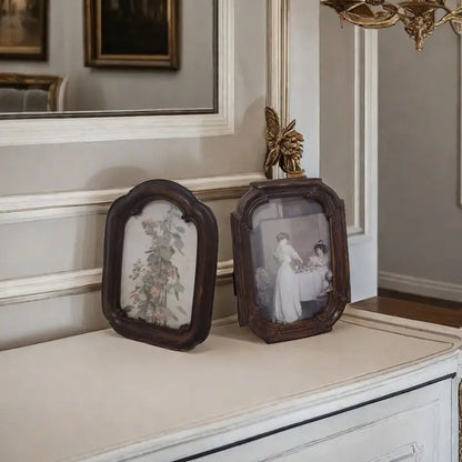 A vintage arched dark wood picture frame