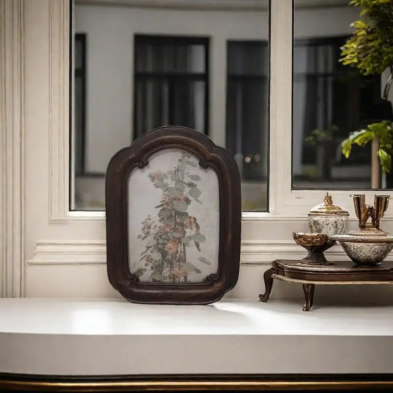 A vintage arched dark wood picture frame