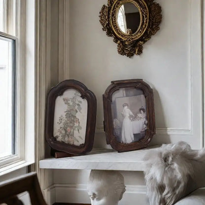 A vintage arched dark wood picture frame