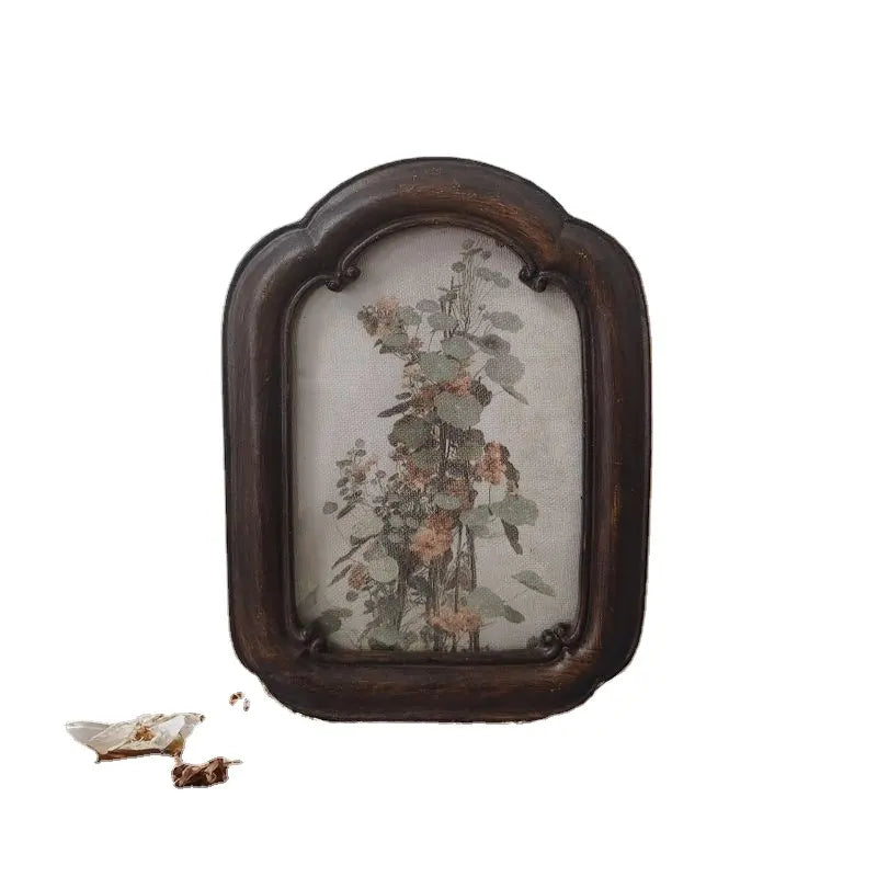 A vintage arched dark wood picture frame