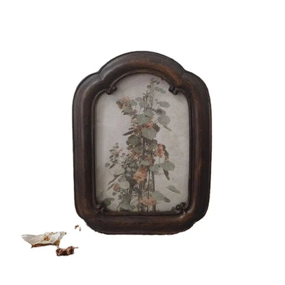 A vintage arched dark wood picture frame