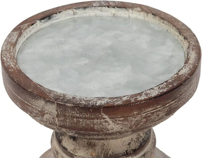 A pair of tall, hand-carved wooden pillar candle holders with a distressed black finish
