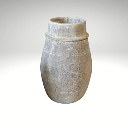 A vintage barrel-shaped carved wooden vessel 