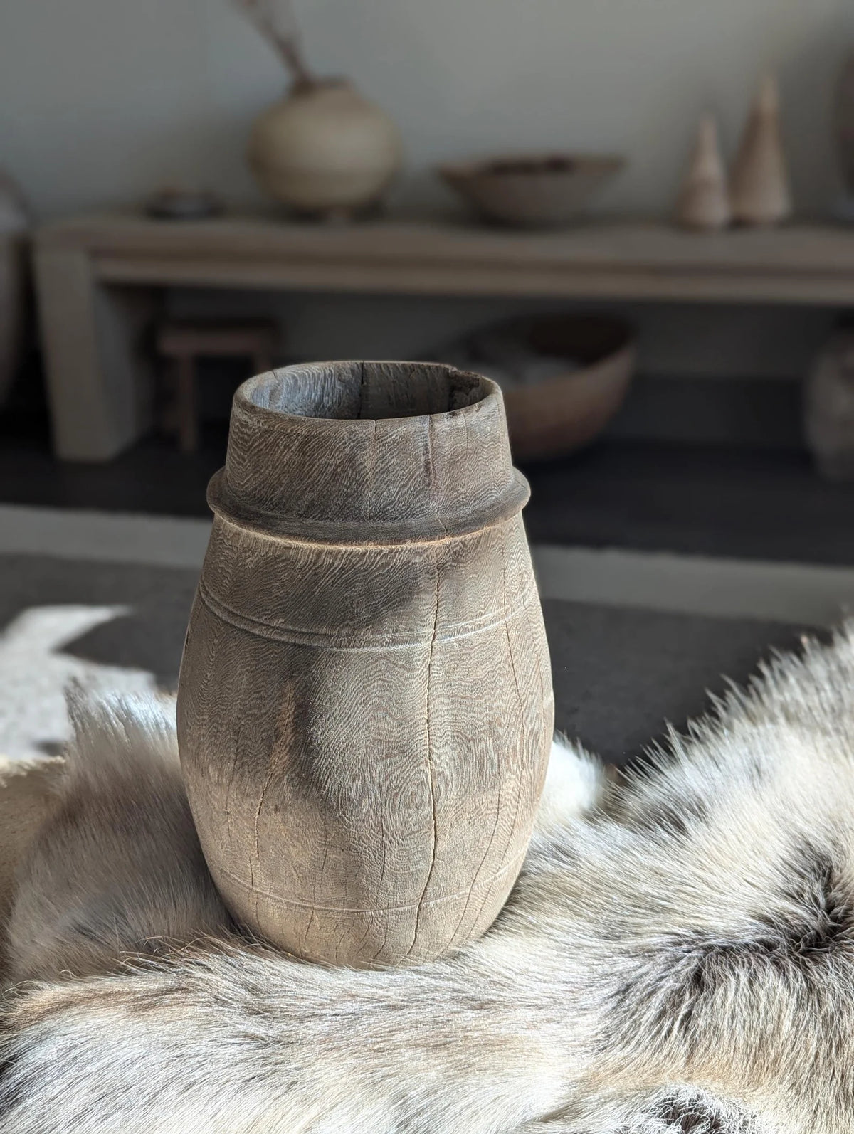 A vintage barrel-shaped carved wooden vessel 
