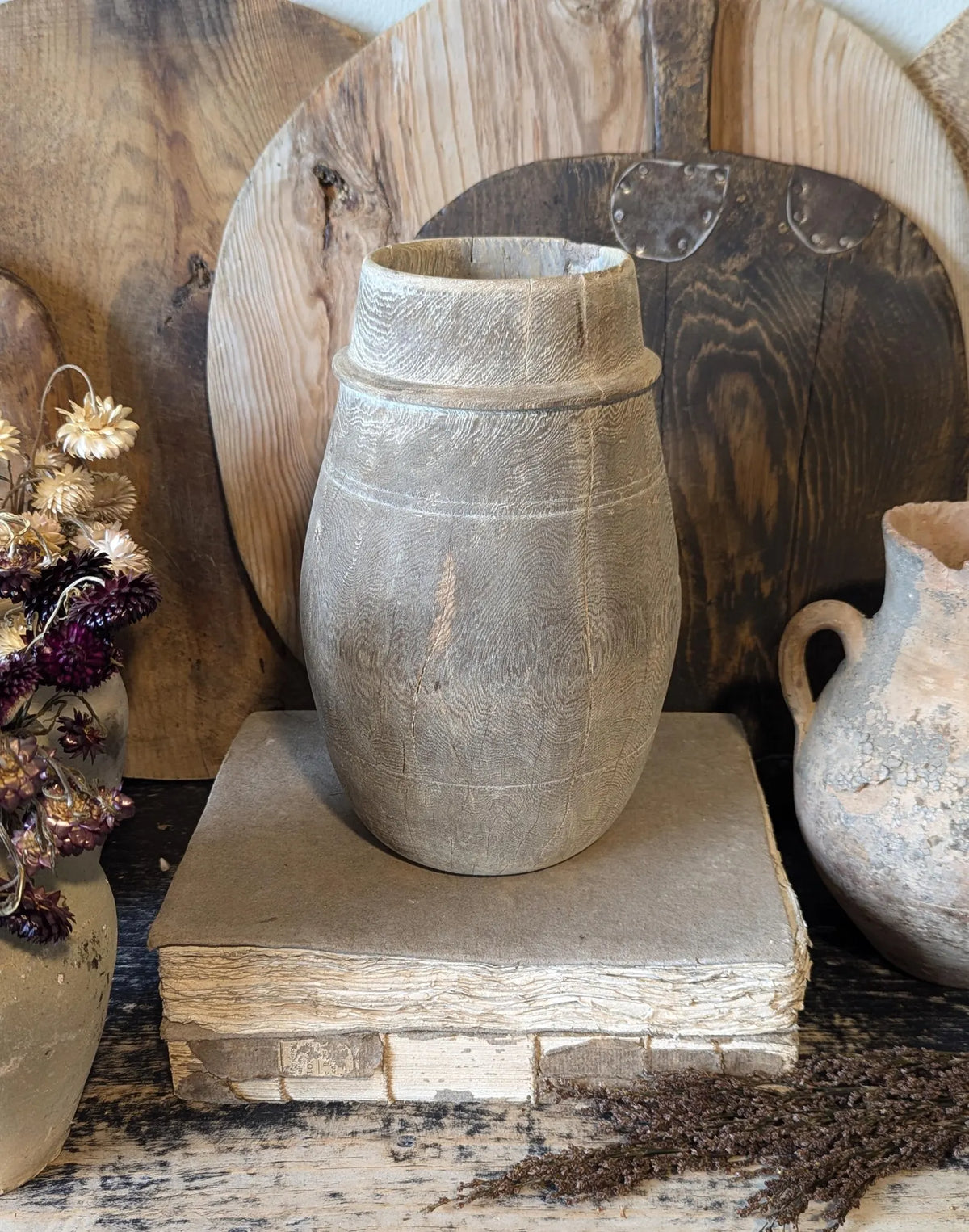 A vintage barrel-shaped carved wooden vessel 