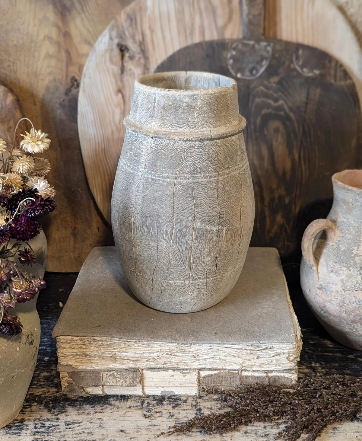 A vintage barrel-shaped carved wooden vessel 