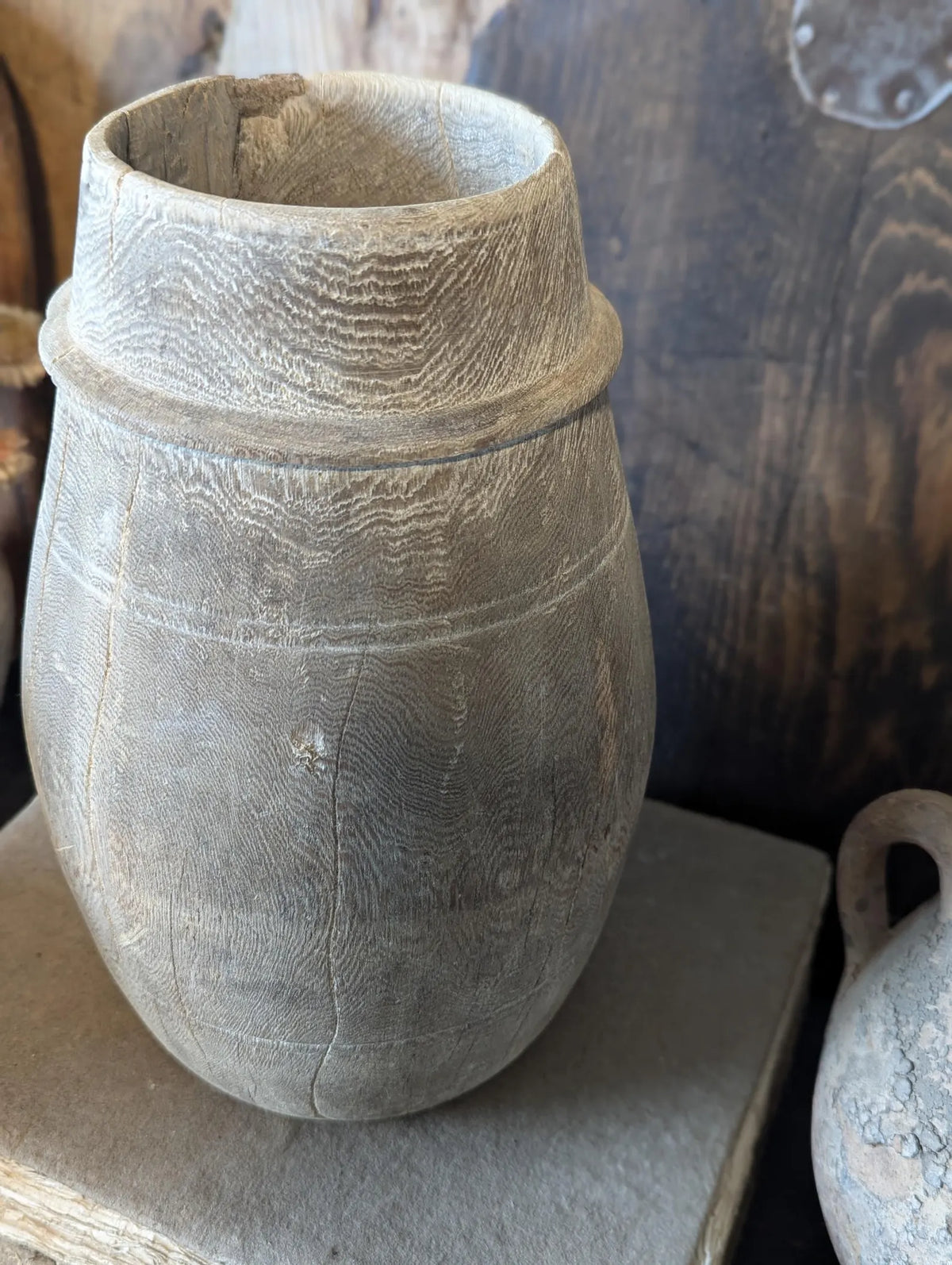 A vintage barrel-shaped carved wooden vessel