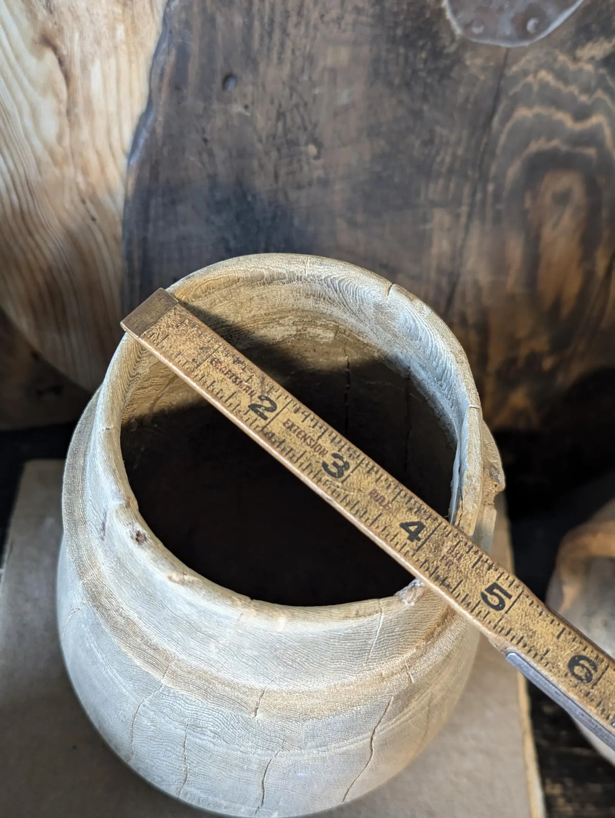 A vintage barrel-shaped carved wooden vessel