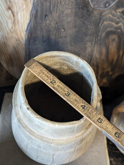 A vintage barrel-shaped carved wooden vessel