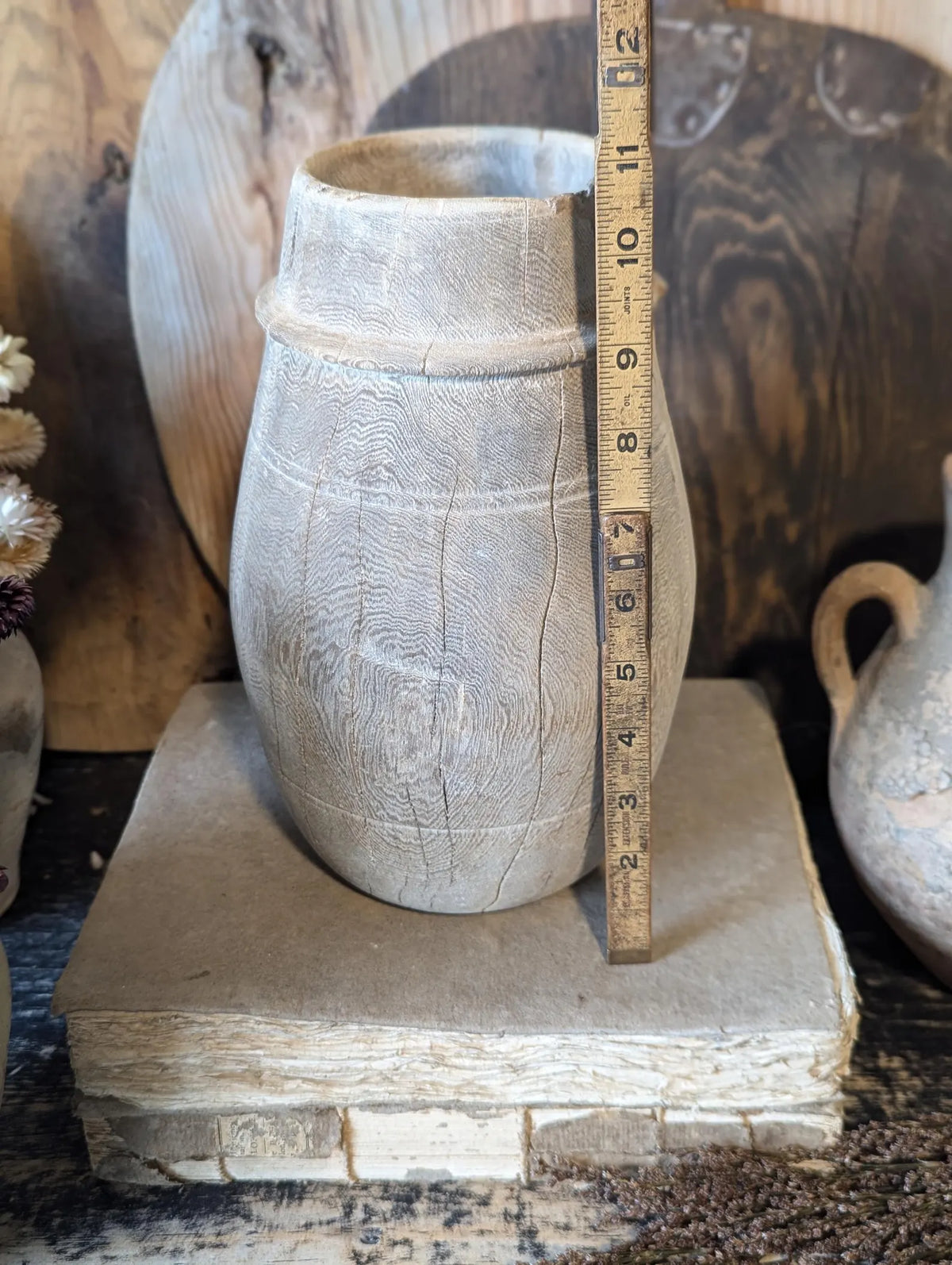 A vintage barrel-shaped carved wooden vessel