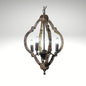 Rustic wooden orb chandelier with an antiqued gold finish and four candelabra lights.