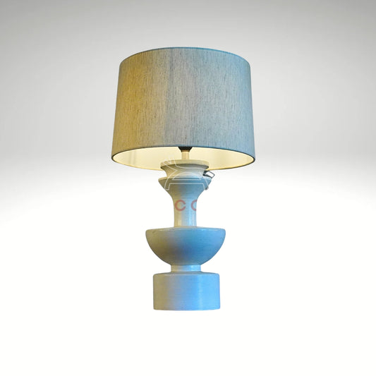 Modern geometric ceramic bedside lamp with contemporary abstract white base and fabric shade for living room decor.