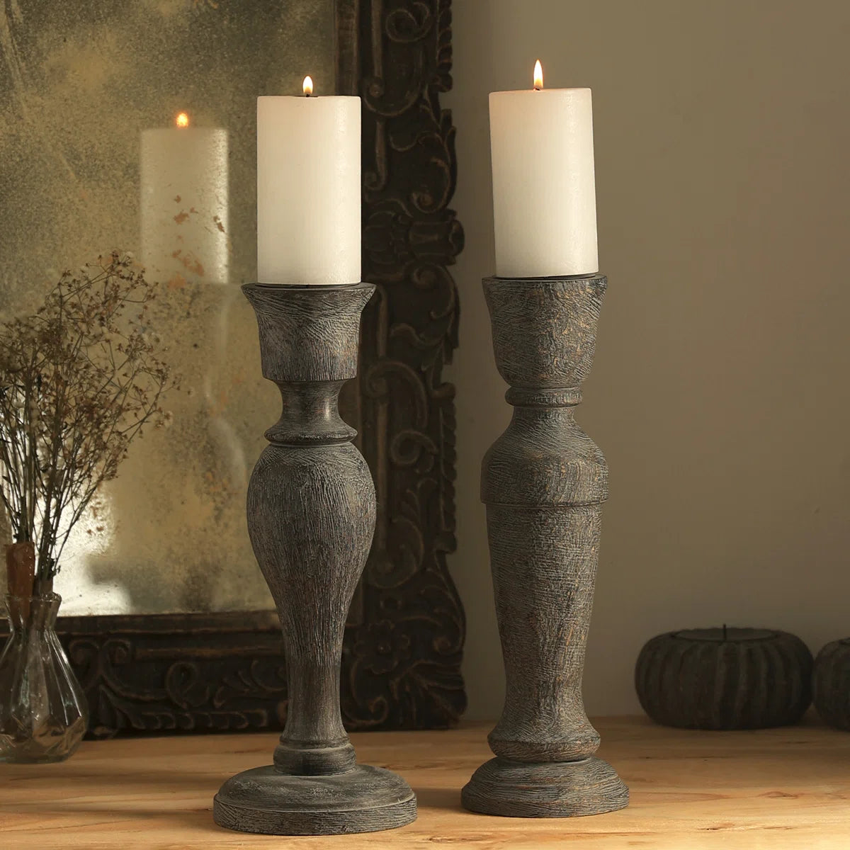 A pair of vintage-style distressed grey wooden candlestick holders