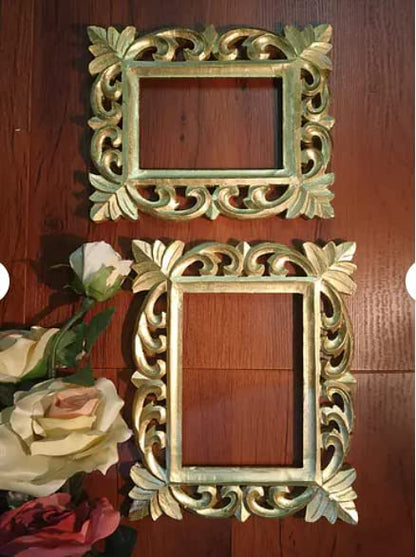 Two ornate gold-carved wooden picture frames
