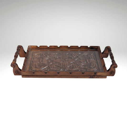 A rectangular wooden serving tray with detailed floral carvings on both handles and a smooth natural grain finish.