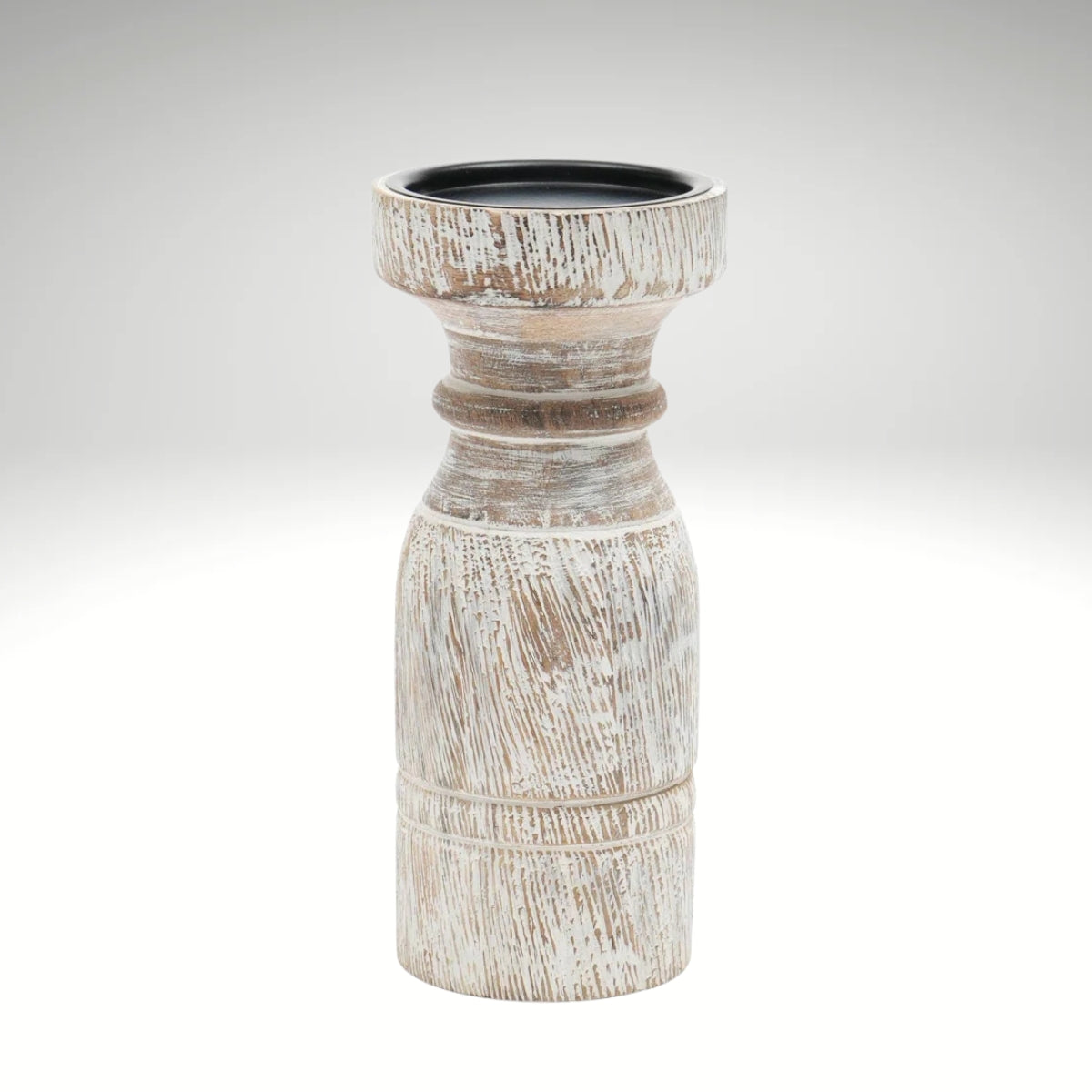 A rustic whitewashed wooden pillar candle holder with a distressed finish