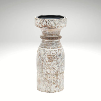 A rustic whitewashed wooden pillar candle holder with a distressed finish