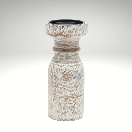 A rustic whitewashed wooden pillar candle holder with a distressed finish