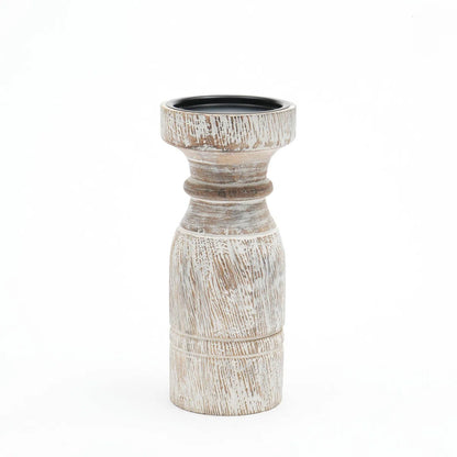 A rustic whitewashed wooden pillar candle holder with a distressed finish