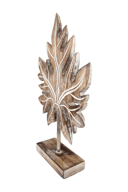 Carved wooden tropical leaf sculpture on a stand.