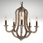 A 5-light rustic farmhouse chandelier made of distressed weathered wood with vintage candle-style bulbs.