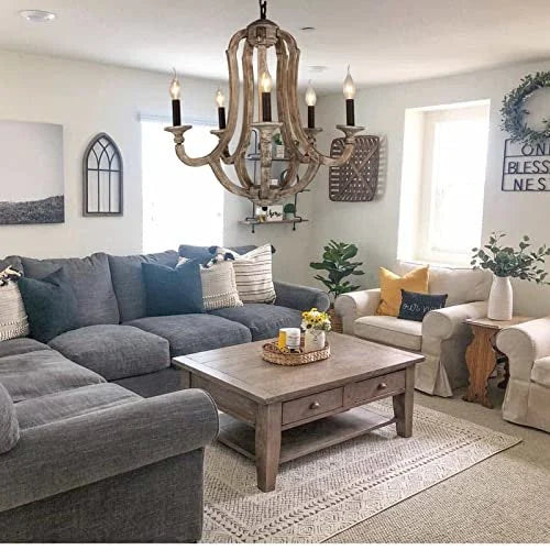A 5-light rustic farmhouse chandelier made of distressed weathered wood with vintage candle-style bulbs.