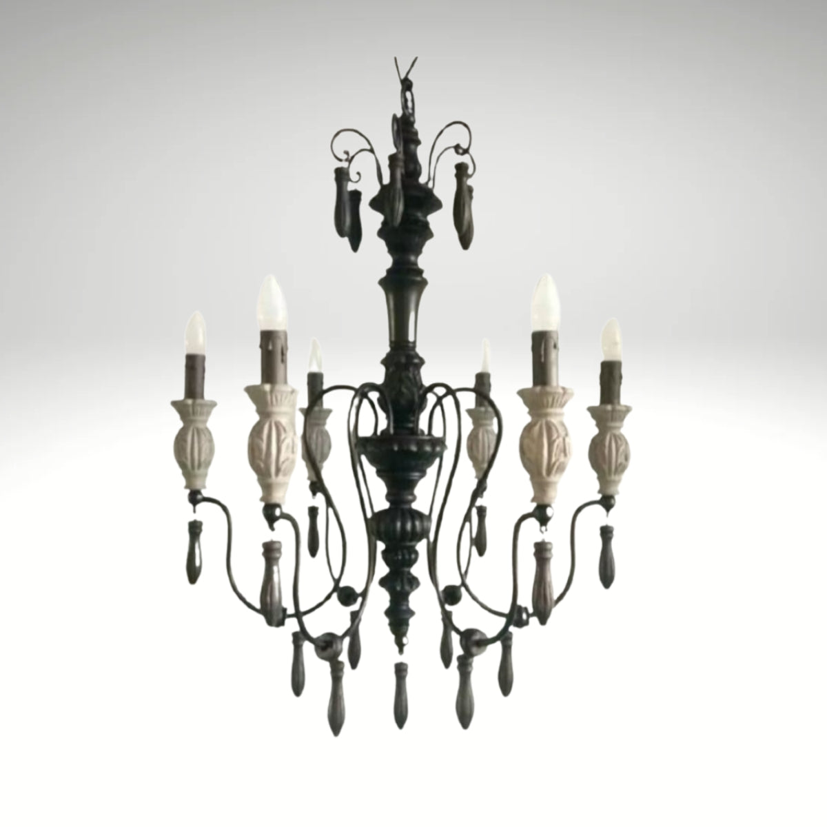 Rustic gothic-inspired wrought iron chandelier featuring carved details and flame-tip lights.