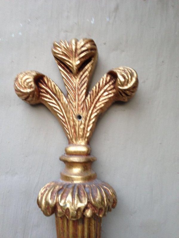 Ornate vintage brass wall lamp with two arms and a detailed gold finish